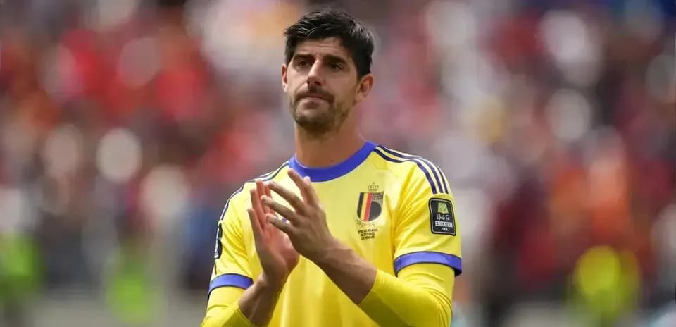 Goalkeeper in yellow jersey clapping to fans