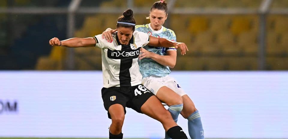 Parma W player challenged by Juventus W player
