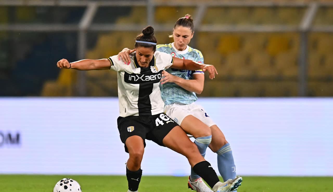 Parma W player challenged by Juventus W player