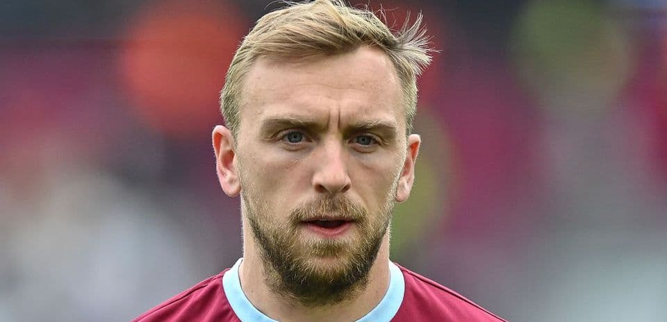Player with short hair and beard wearing team jersey