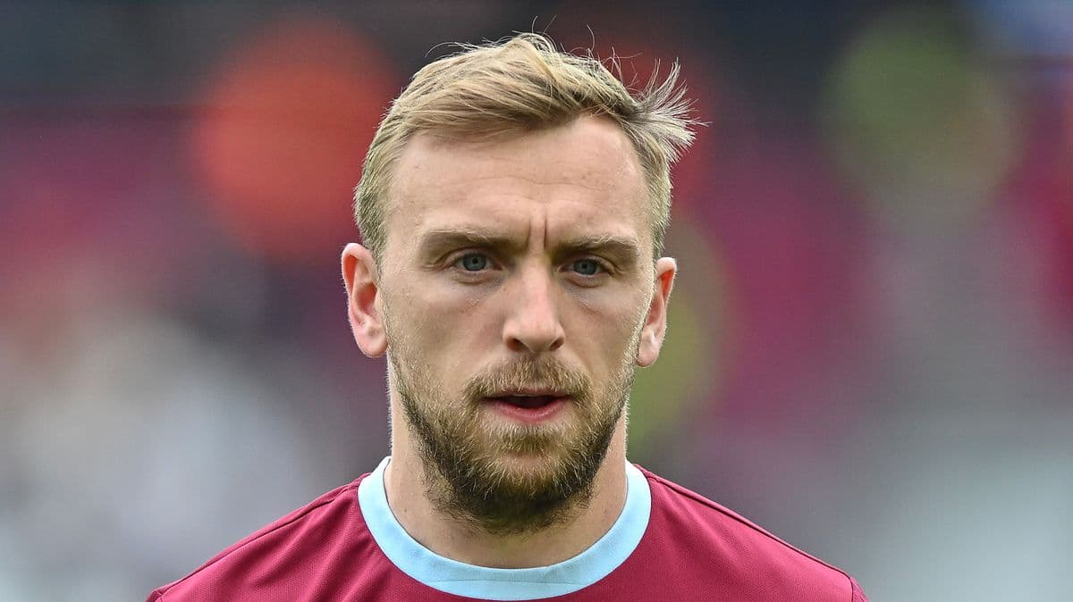 Player with short hair and beard wearing team jersey