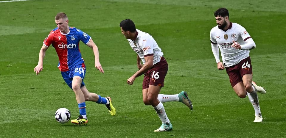 Crystal Palace player dribbling past two opponents