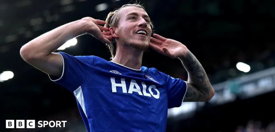 Player celebrating a goal with hands to ears