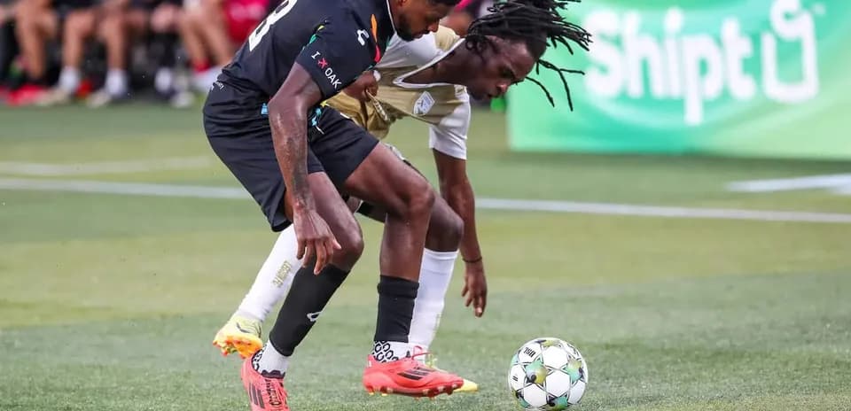 Two players contesting for the ball in match