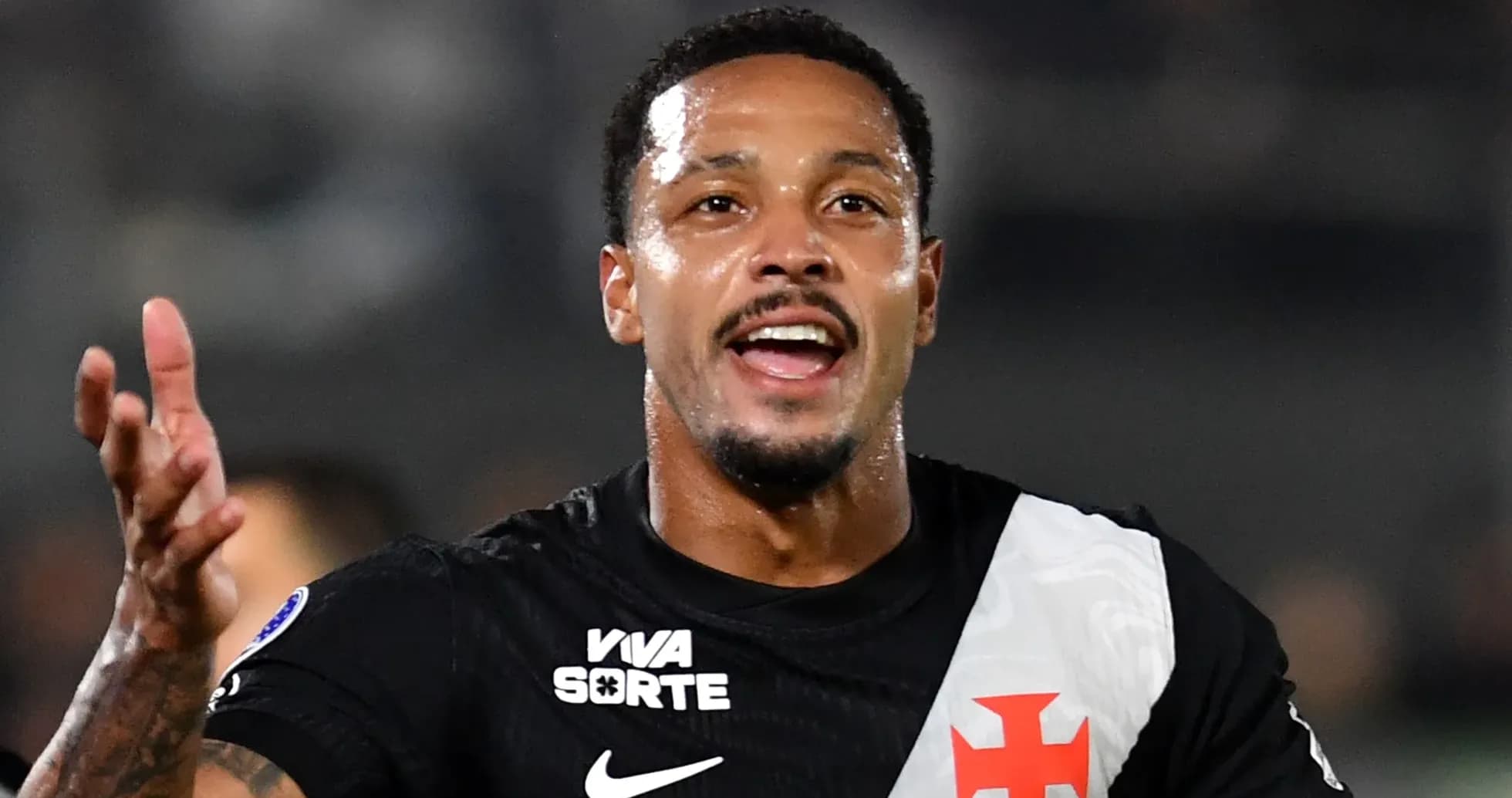 Player celebrating with arms raised on the field