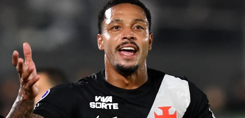 Player celebrating with arms raised on the field