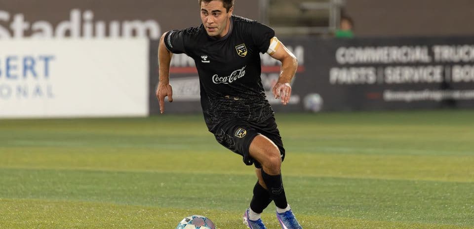 Player running with ball during football match