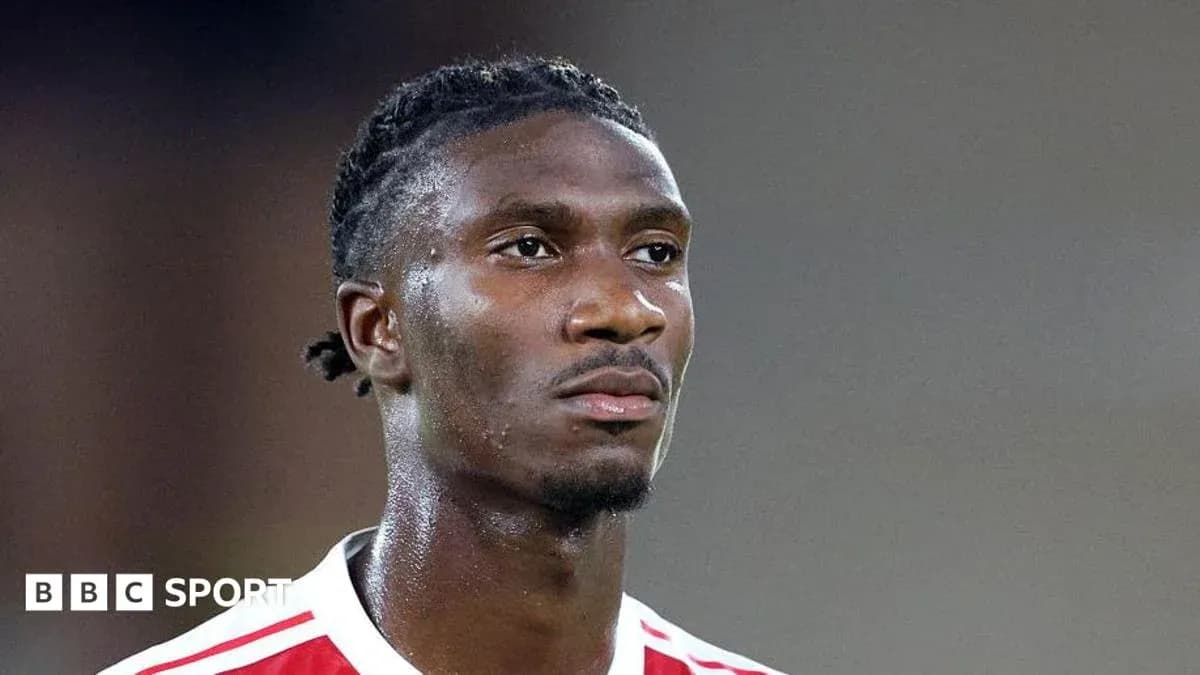 Player in red and white jersey during match