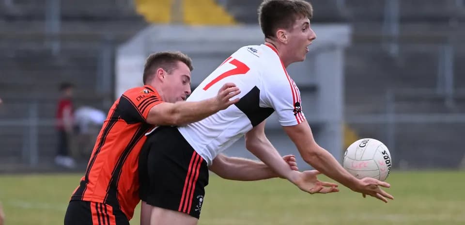 Two players competing for possession of the ball