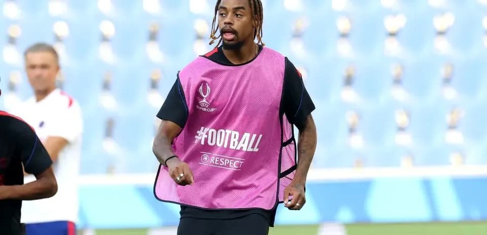 Player training in pink bib during warm-up session