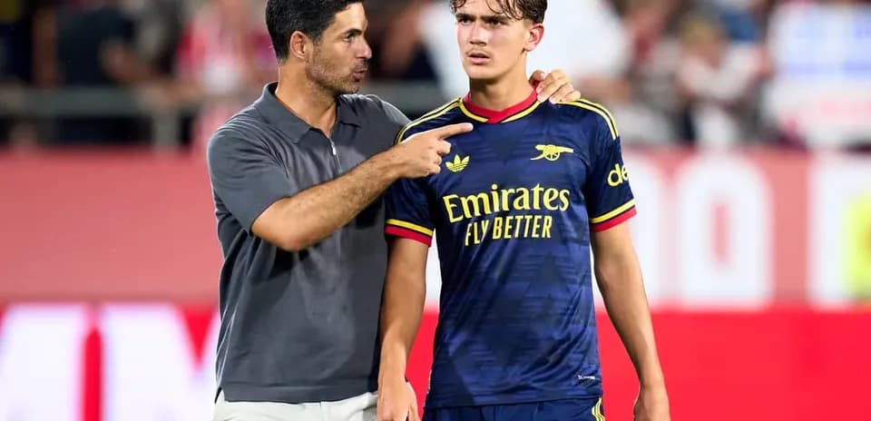 Coach speaking to player on the sidelines