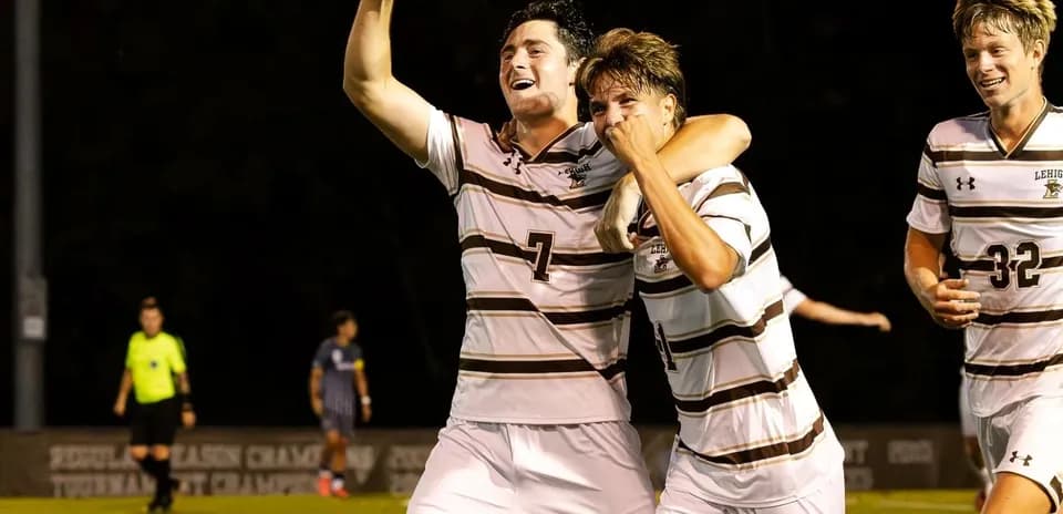 Players celebrating a goal during a soccer match