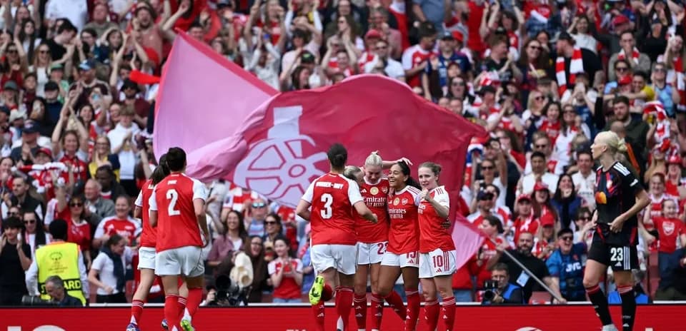 Arsenal players celebrating with fans at stadium