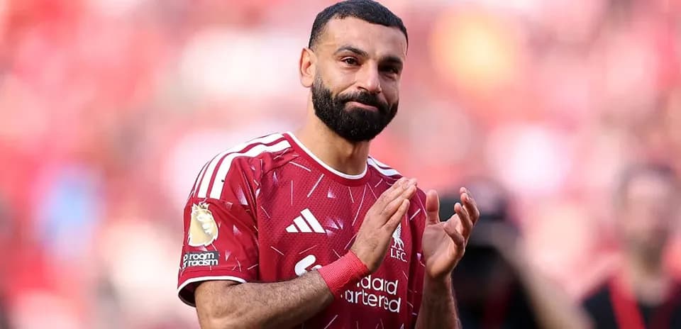 Player applauding fans in Liverpool jersey