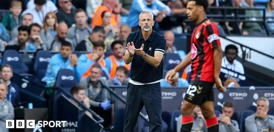 Manager directing player during match at Etihad Stadium