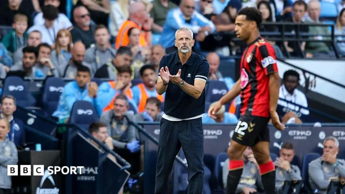 Manager directing player during match at Etihad Stadium