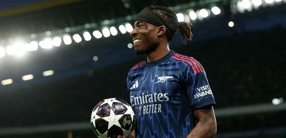 Player holding a UEFA Champions League ball on field