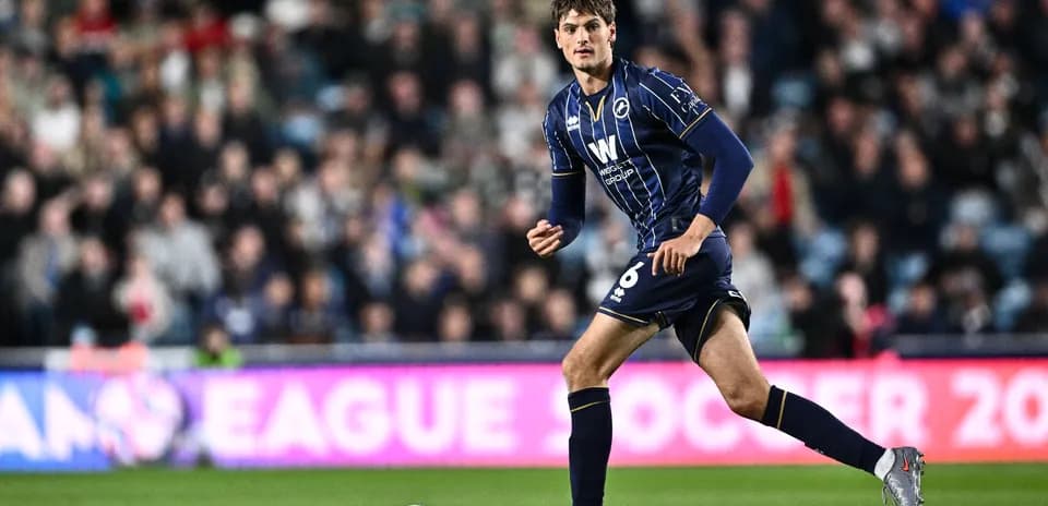 Player in blue kit running on the pitch