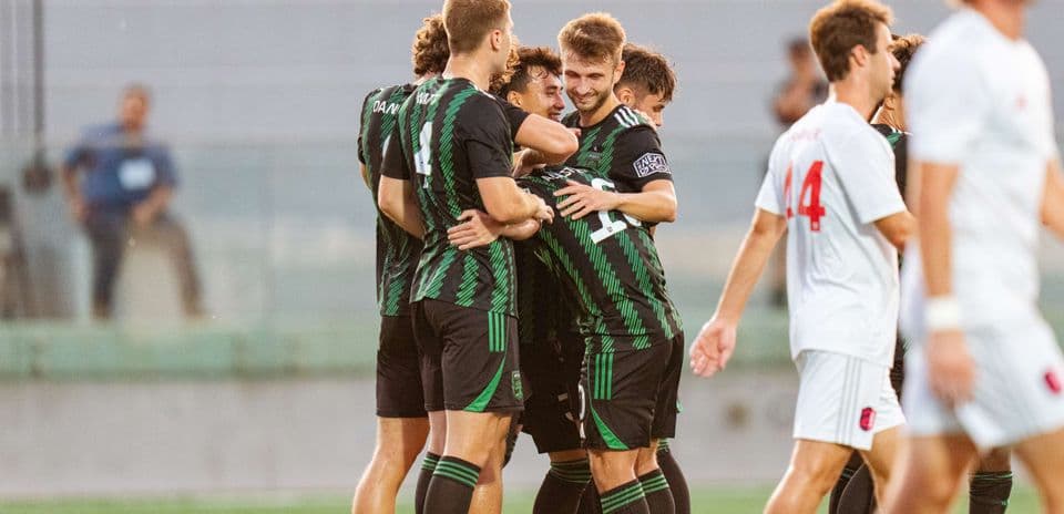 Players celebrating a goal during Austin II match