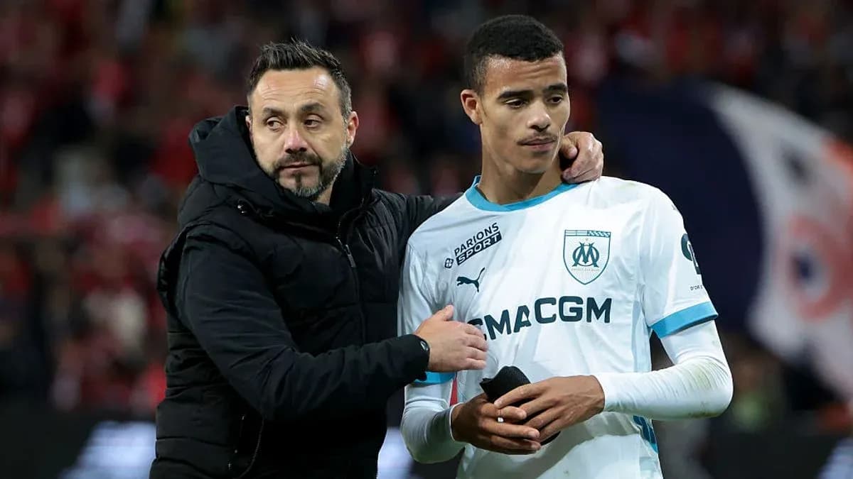 Coach comforting player after match at stadium