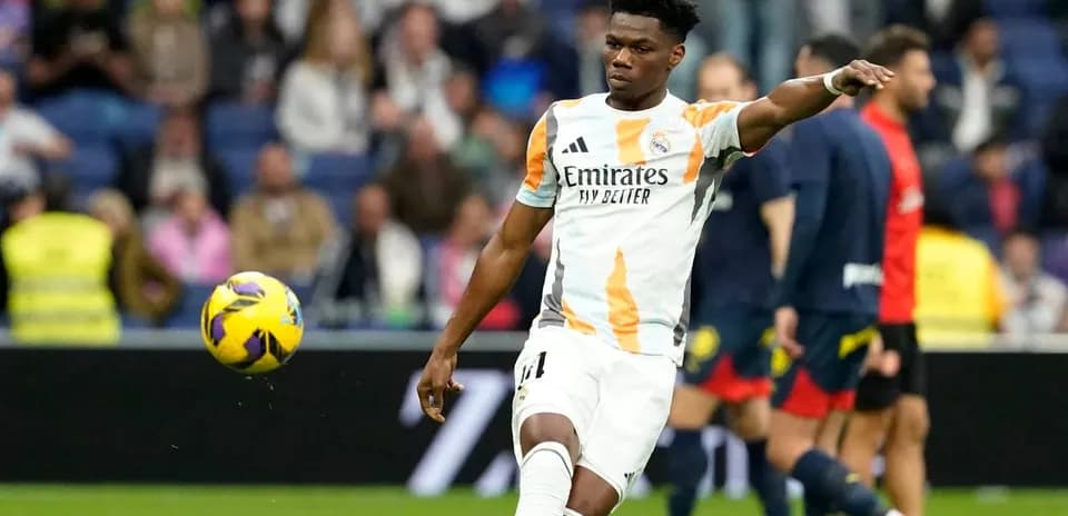 Player in Real Madrid kit kicking a football