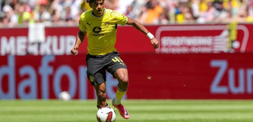 Player in yellow jersey dribbling ball on field