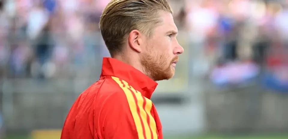 Player in red jacket during warm-up on field