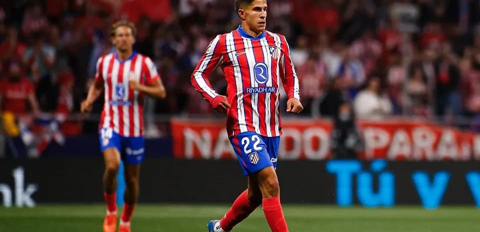 Atletico Madrid player running with the ball