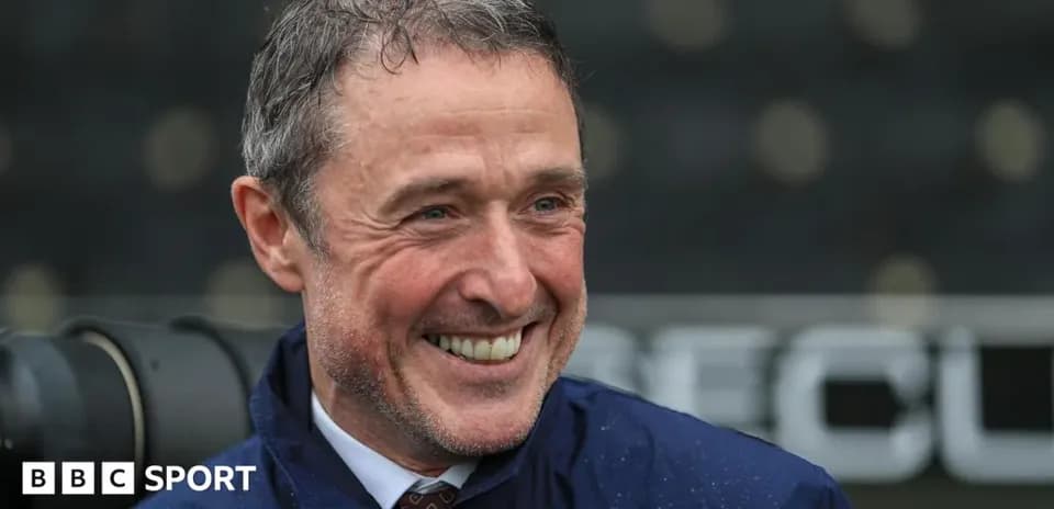 Man smiling during a press event outdoors