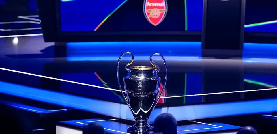 Champions League trophy on stage with Arsenal logo