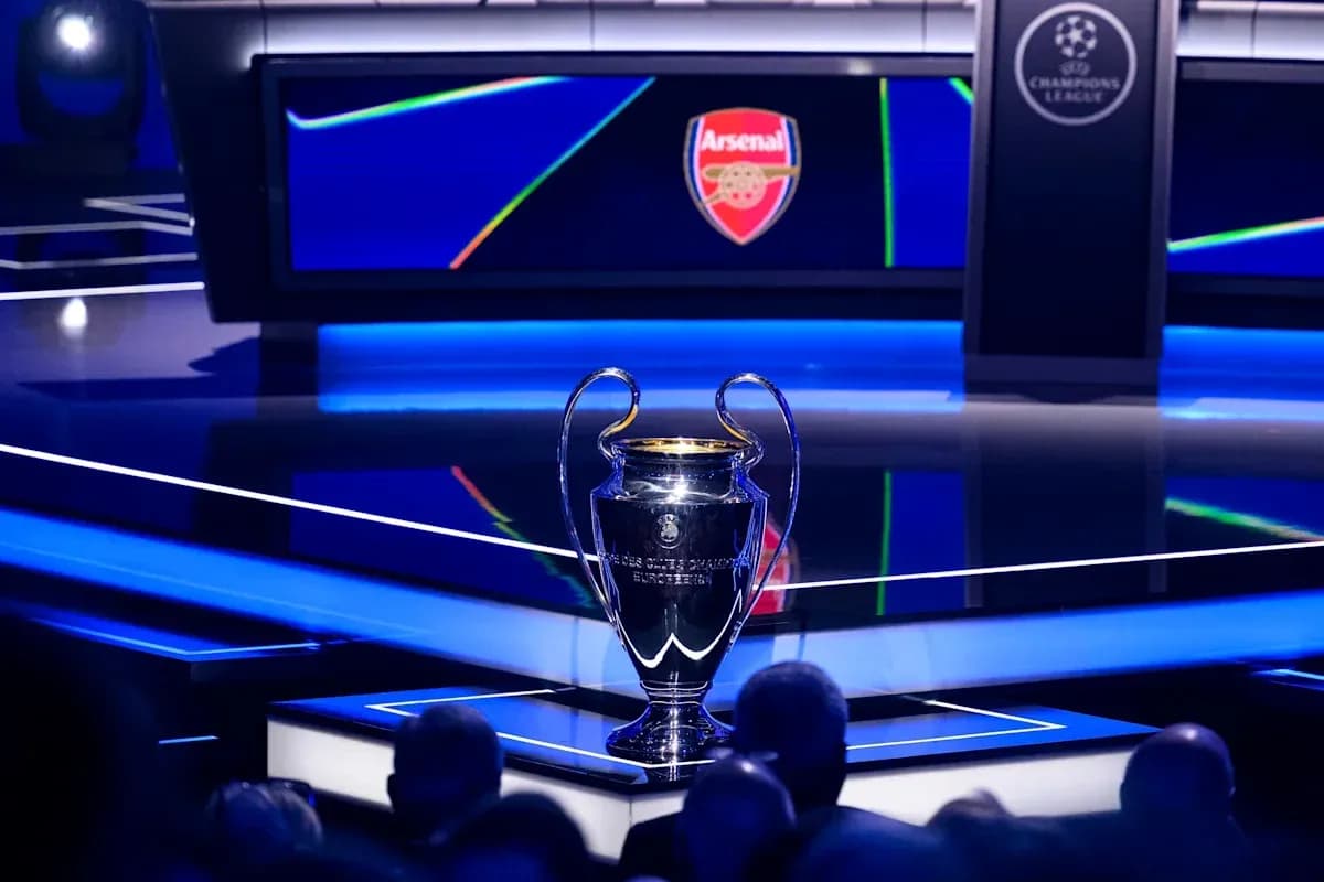 Champions League trophy on stage with Arsenal logo