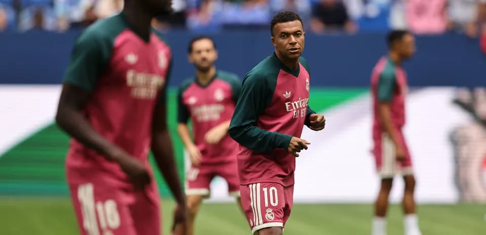 Players warming up in Real Madrid training kits