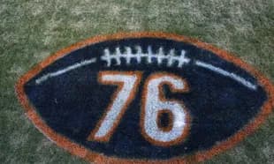 Painted football logo with number 76 on grass