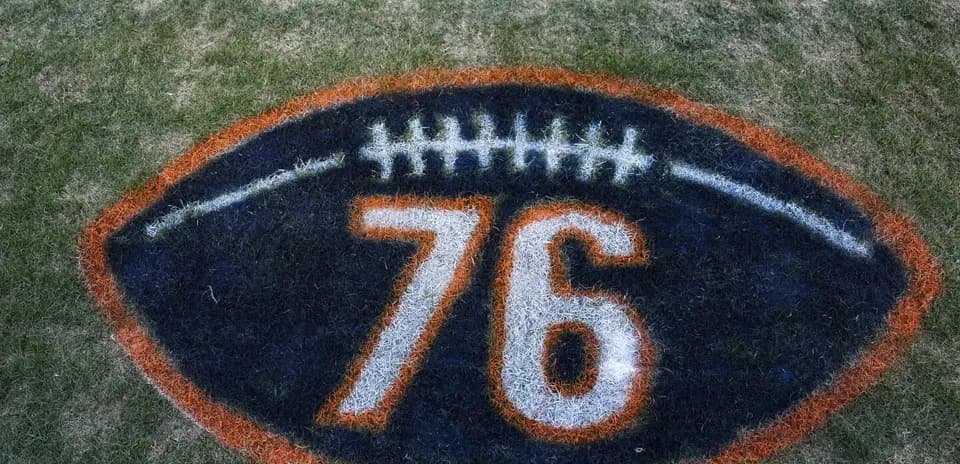 Painted football logo with number 76 on grass
