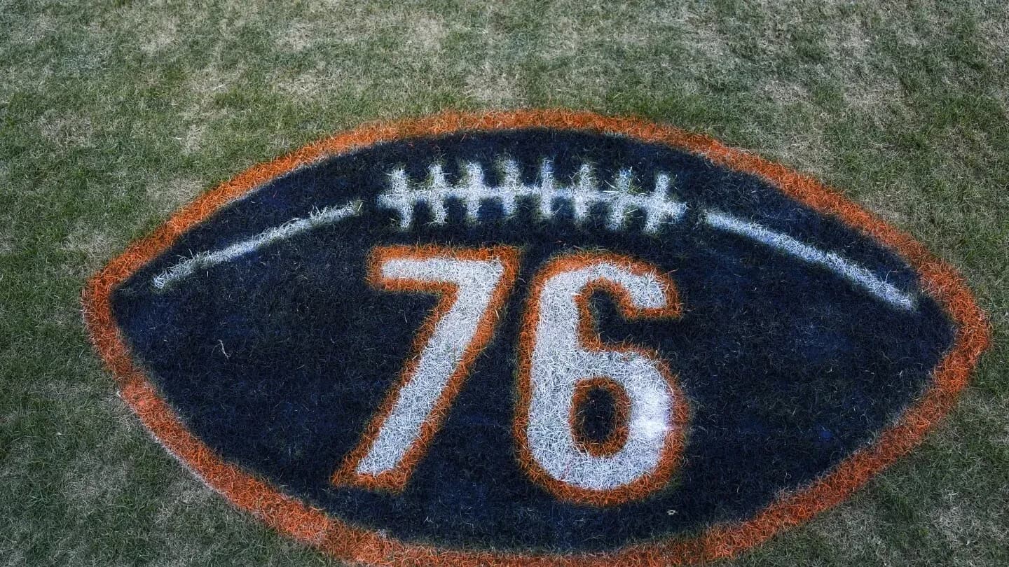 Painted football logo with number 76 on grass