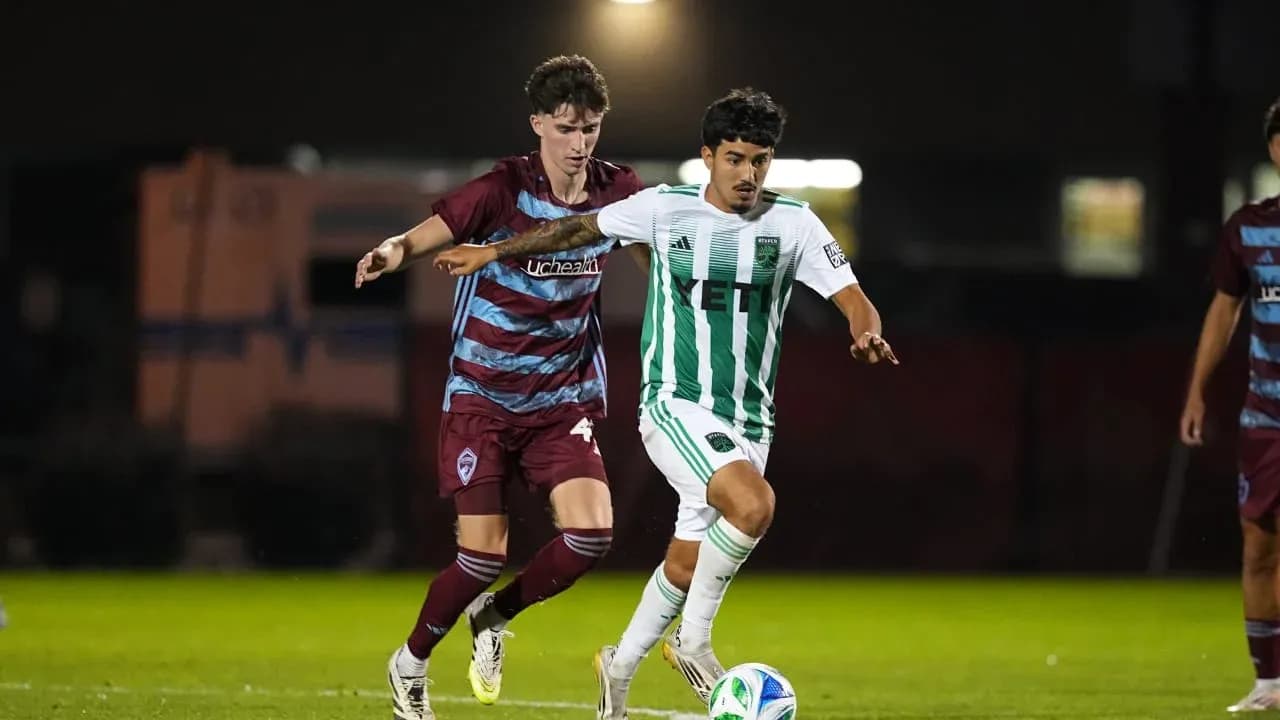 Two players competing for the ball in match
