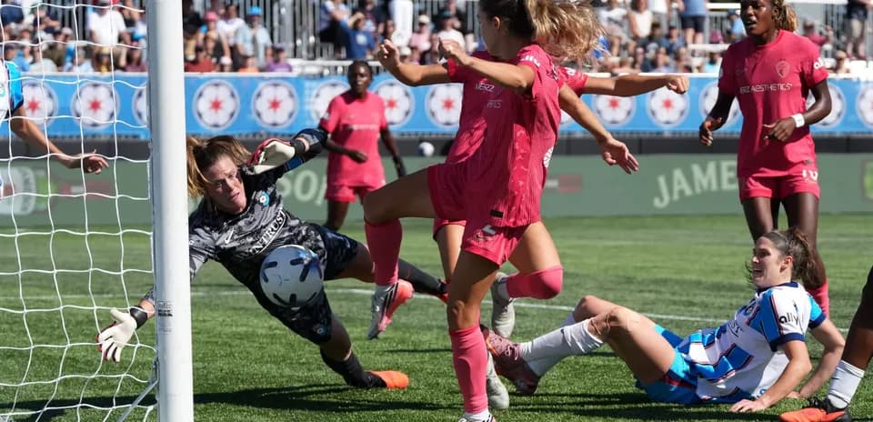 Goalkeeper attempting to save shot during match