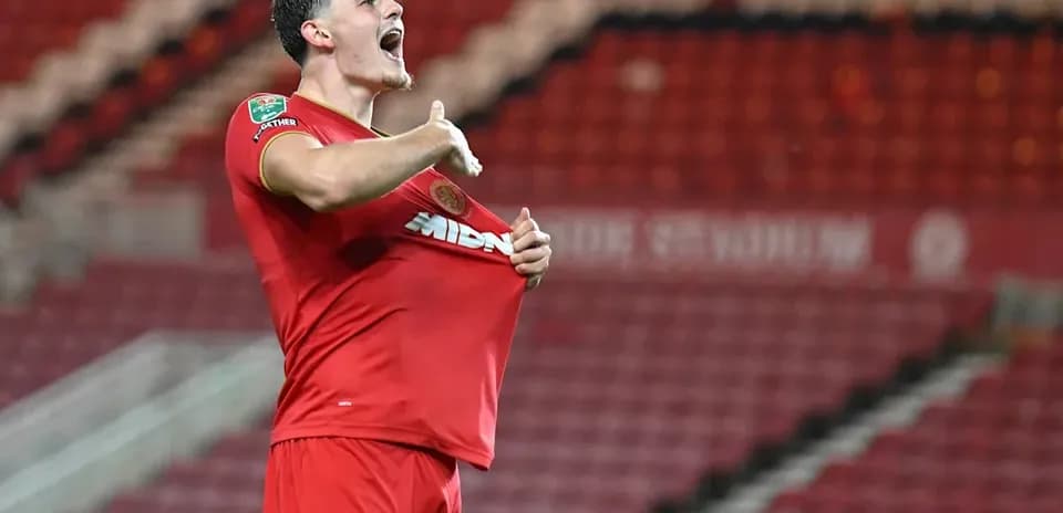 Player celebrating by pulling up jersey after goal