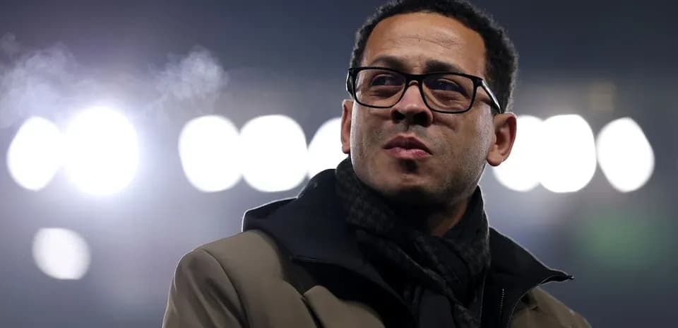 Man in glasses standing under stadium lights