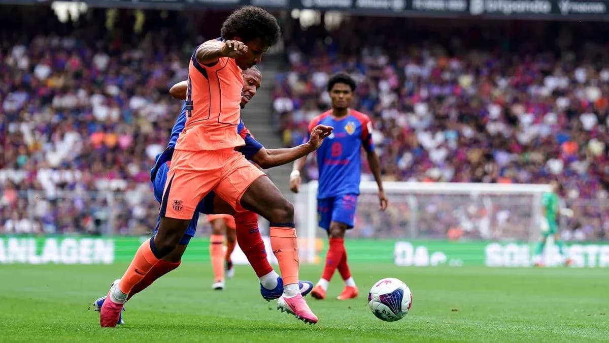Player in orange tackling opponent during match Player in orange tackling opponent during match
