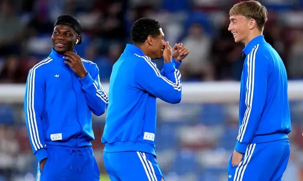 Three players in blue tracksuits laughing together Three players in blue tracksuits laughing together