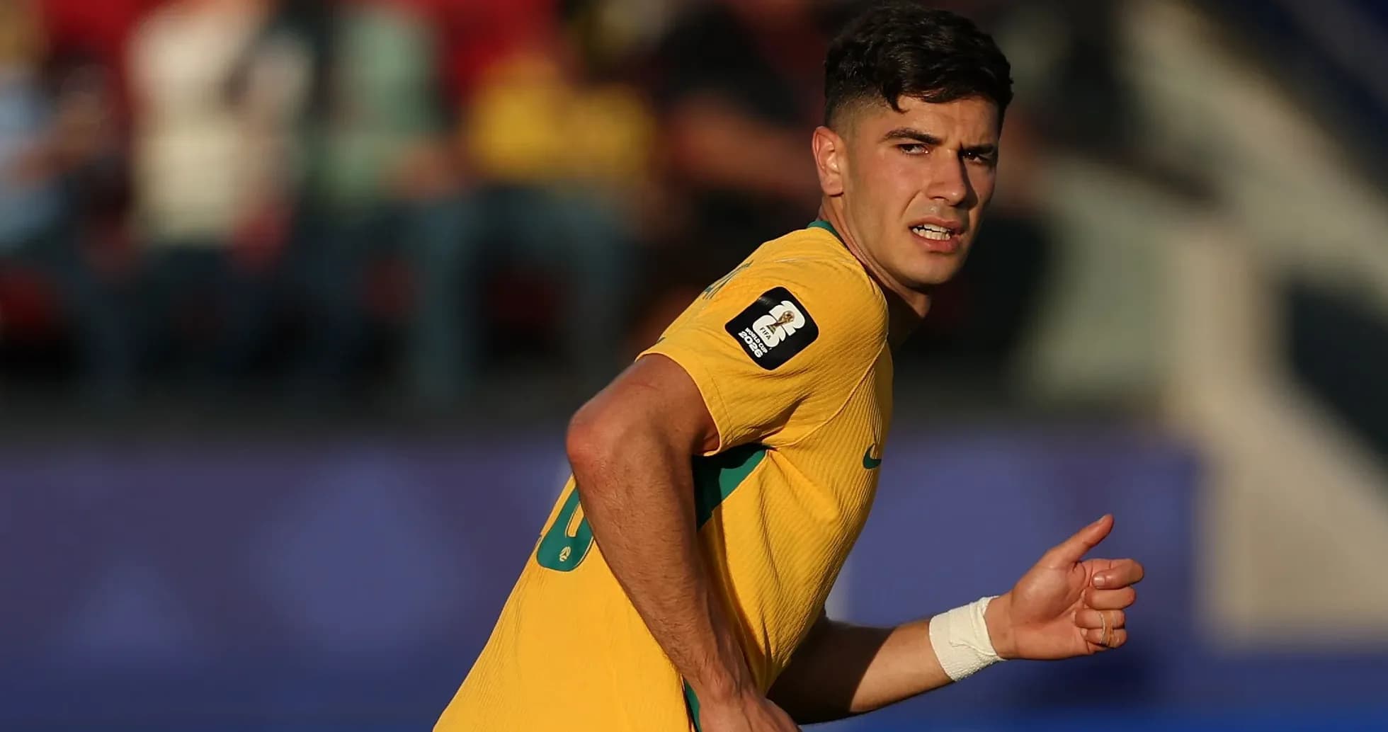 Player in yellow jersey running during match Player in yellow jersey running during match