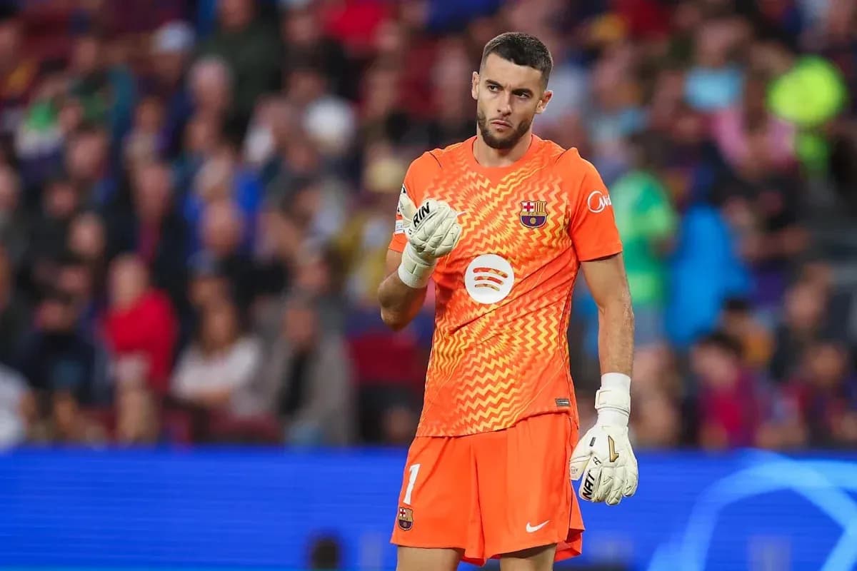 Goalkeeper in orange kit during match at stadium Goalkeeper in orange kit during match at stadium