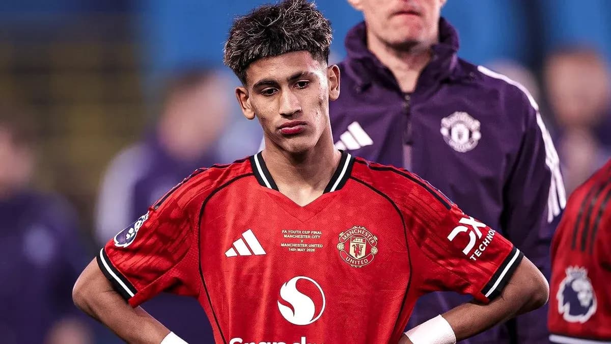 Young player in Manchester United jersey looking down Young player in Manchester United jersey looking down