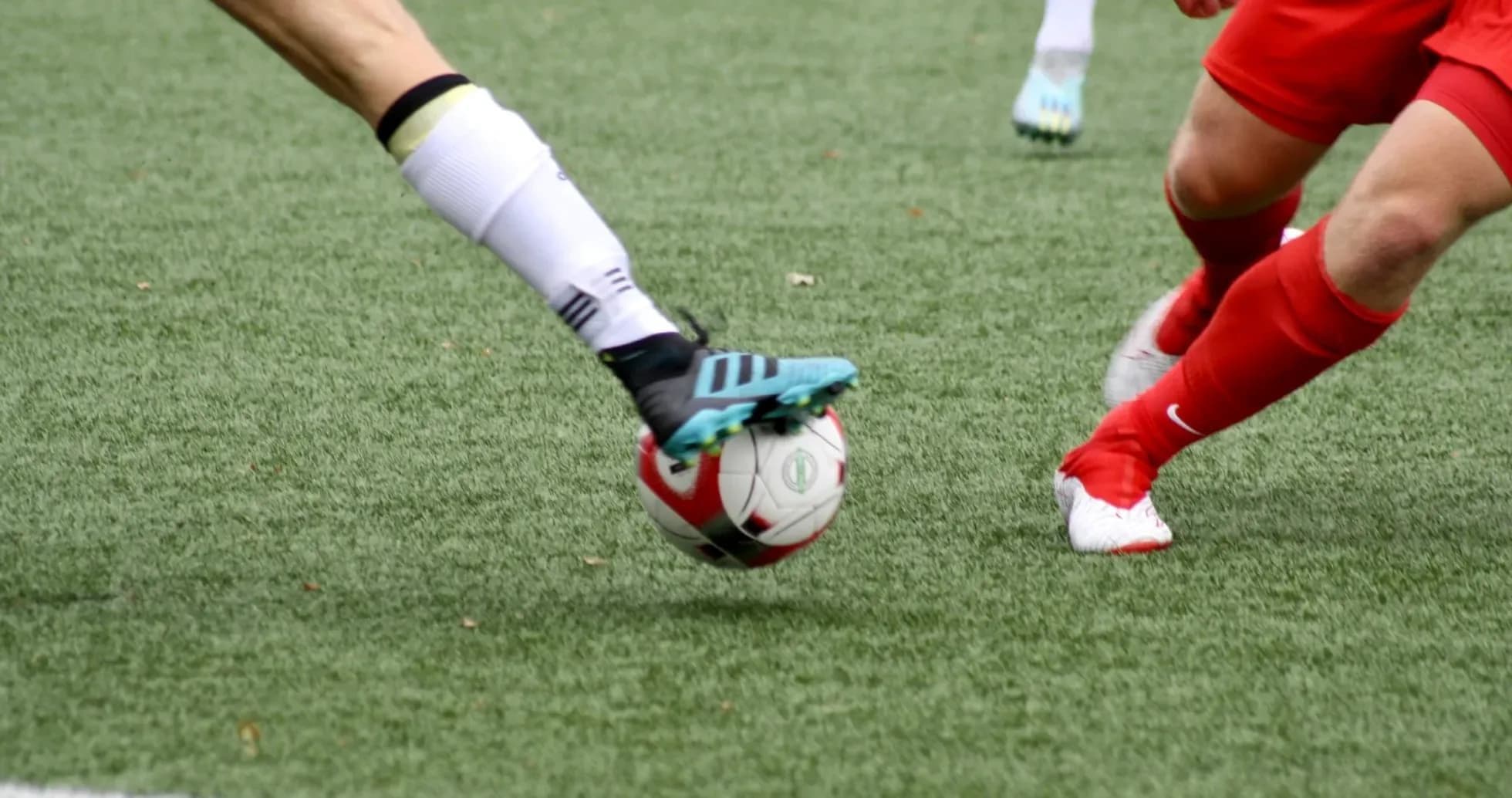 Players competing for the ball in football match Players competing for the ball in football match