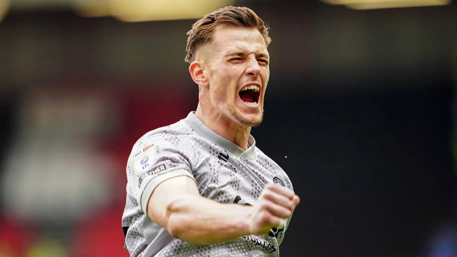 Player celebrating a goal with raised fist Player celebrating a goal with raised fist