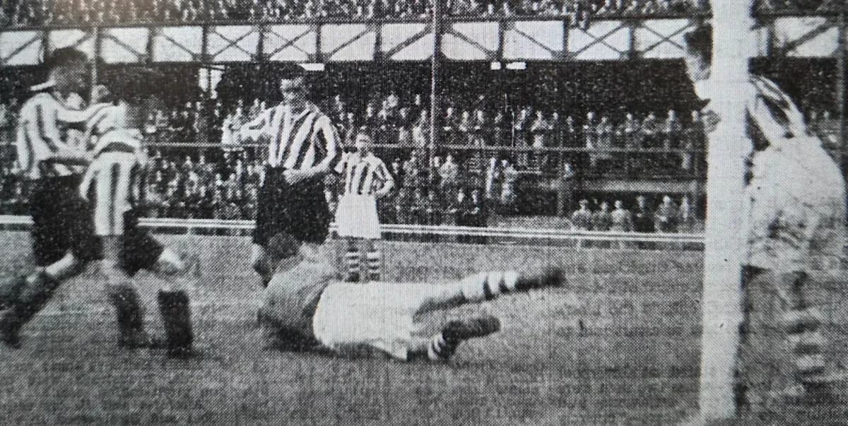Players contesting near the goal during a match Players contesting near the goal during a match