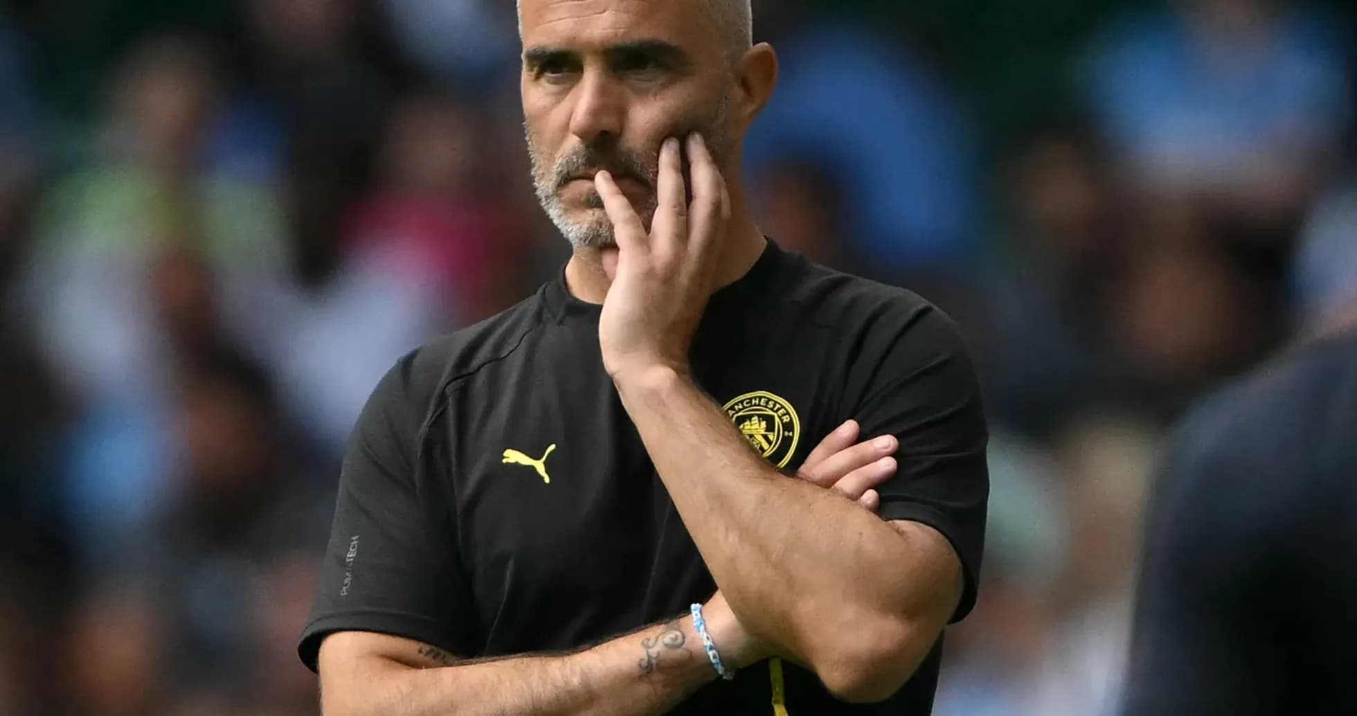 Manager observing the match with thoughtful expression Manager observing the match with thoughtful expression