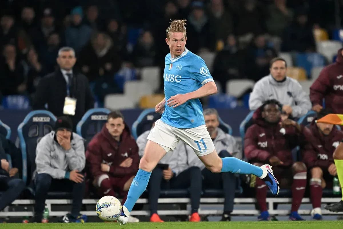 Player in blue kit running with the ball Player in blue kit running with the ball