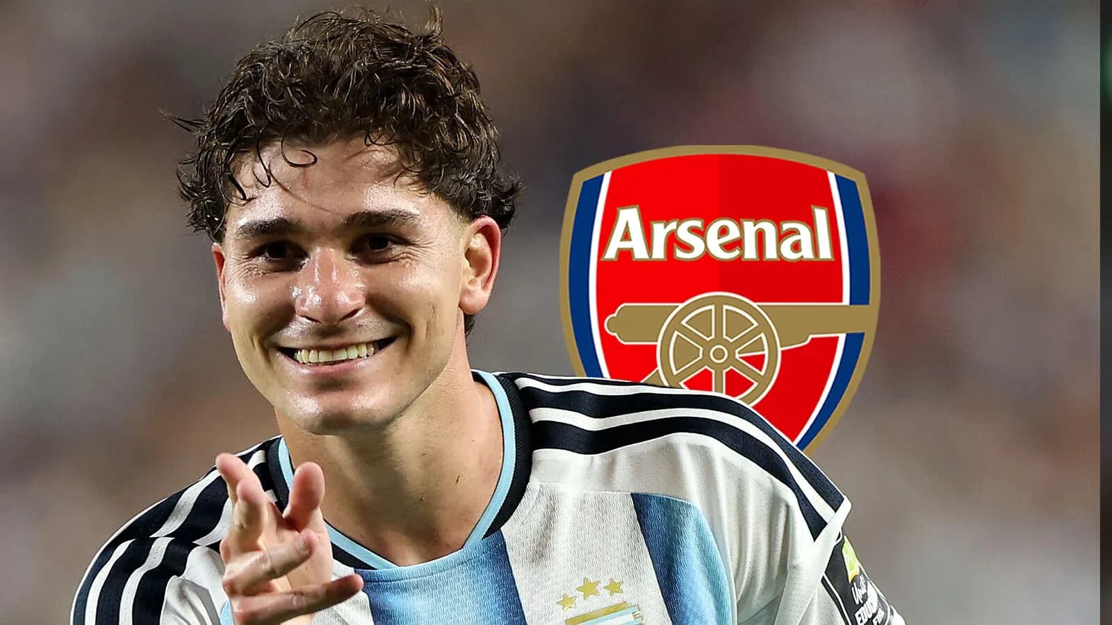 Player celebrating with Arsenal logo in background Player celebrating with Arsenal logo in background